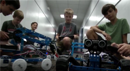 Five students exploring robotics 